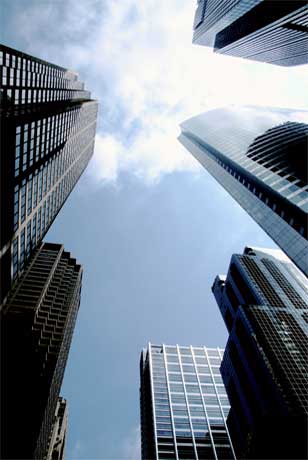 Photo looking up past office buildings at the sky